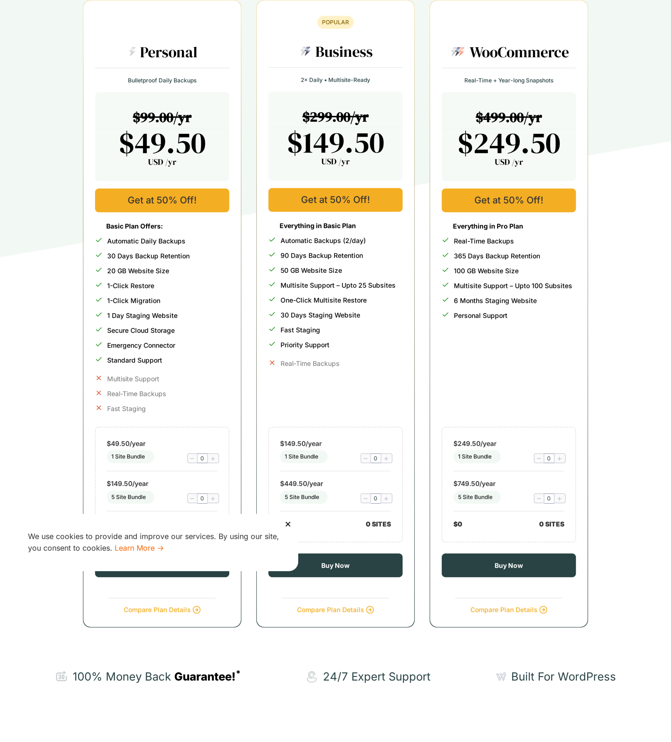 BlogVault pricing page showing the three plan cards Personal with a struck-through 99 USD per year and a discounted 49.50 USD per year, Business with the POPULAR badge and a struck-through 299 USD per year and a discounted 149.50 USD per year, and WooCommerce with a struck-through 499 USD per year and a discounted 249.50 USD per year, each card with a Get at a discount call to action and a feature checklist below: Personal lists Automatic Daily Backups, 30 Days Backup Retention, 20 GB Website Size, 1-Click Restore, 1-Click Migration, 1 Day Staging Website, Secure Cloud Storage, Emergency Connector, and Standard Support, with Multisite Support and Real-Time Backups marked as excluded; Business lists Automatic Backups 2 per day, 90 Days Backup Retention, 50 GB Website Size, Multisite Support up to 25 Subsites, One-Click Multisite Restore, 30 Days Staging Website, Fast Staging, and Priority Support, with Real-Time Backups marked as excluded; WooCommerce lists Real-Time Backups, 365 Days Backup Retention, 100 GB Website Size, Multisite Support up to 100 Subsites, 6 Months Staging Website, and Personal Support.